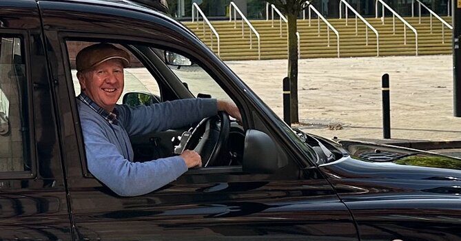 a driver in taxi on driving seat seeing outside