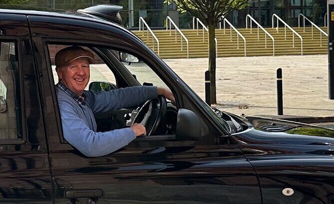 a driver in taxi on driving seat seeing outside