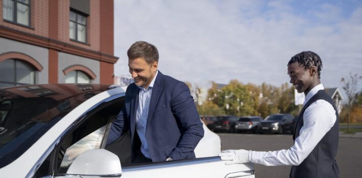 valet-helping-man-side-view-min