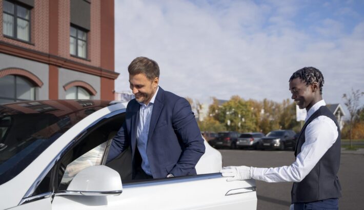 valet-helping-man-side-view-min